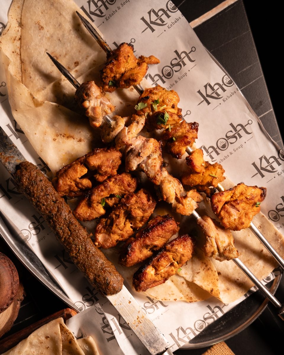 Khosh platter with tikka skewers, seekh and rumali roti